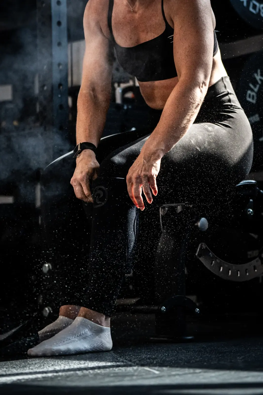 Athlete chalking up during a gym training session