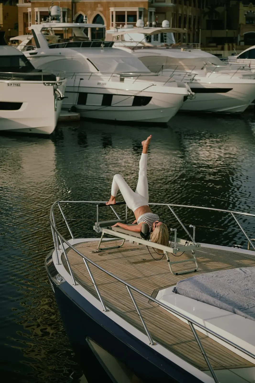 Pilates reformer session on a yacht bow at Dubai Marina