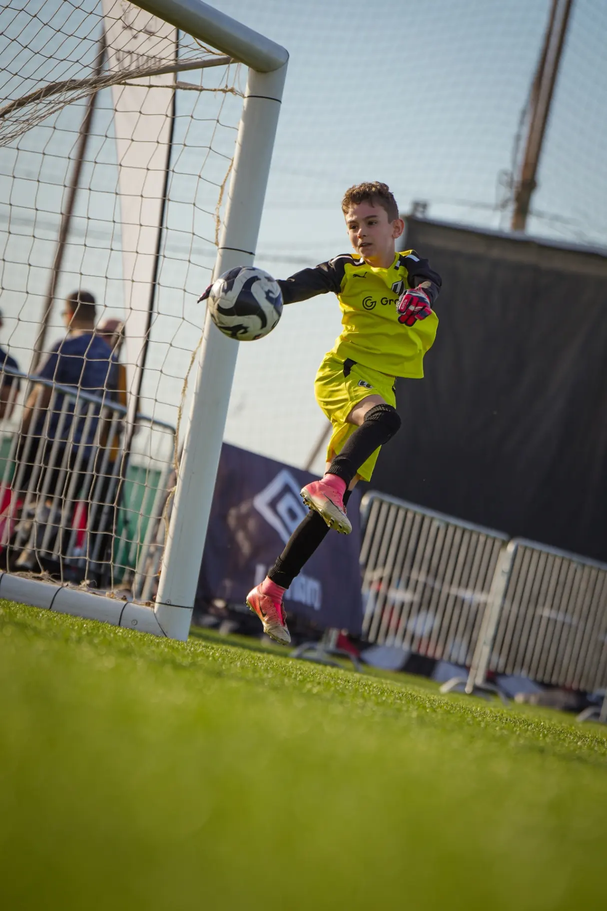 Young goalkeeper mid-air save