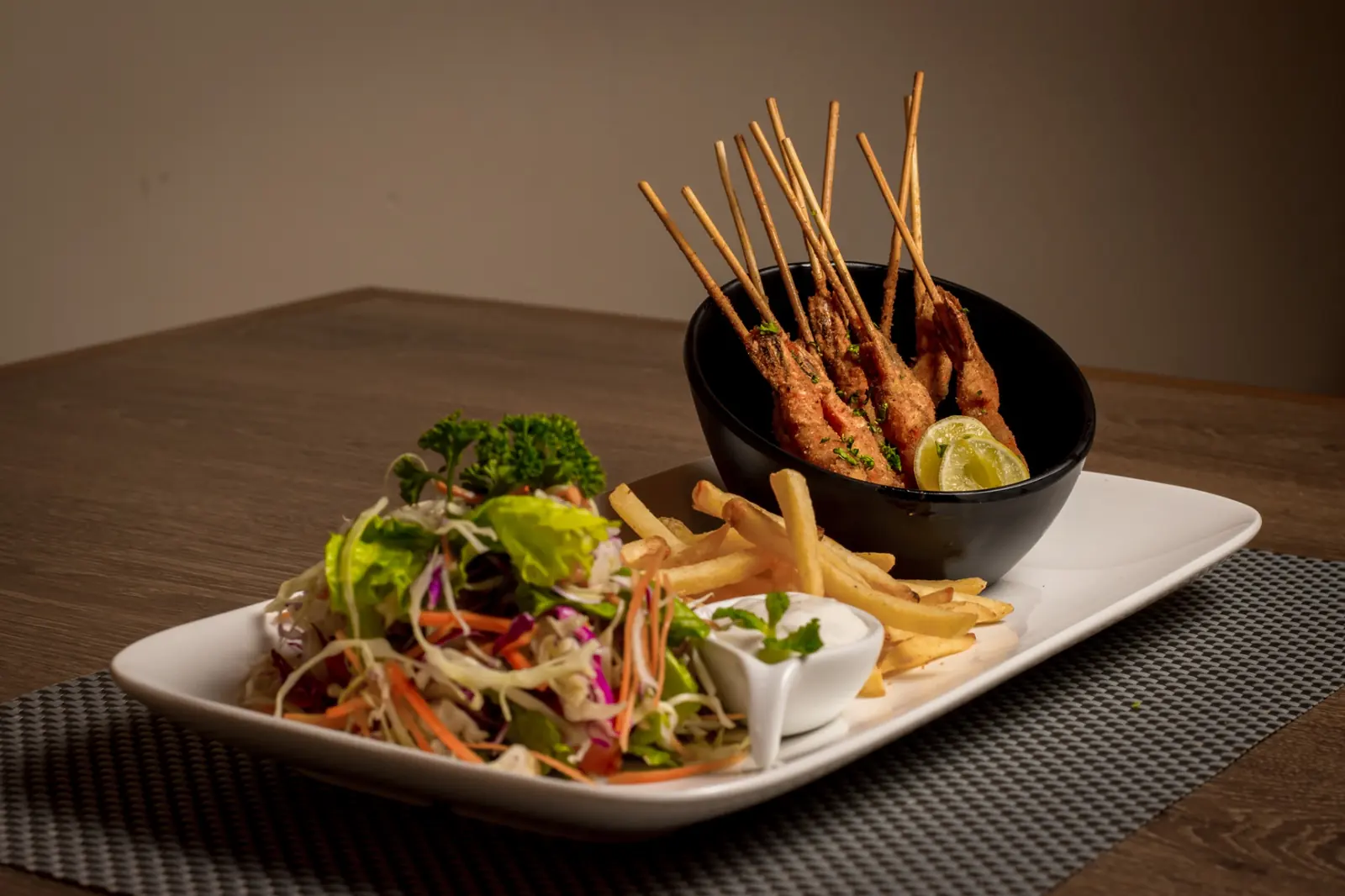 Skewered kebabs with fries and salad